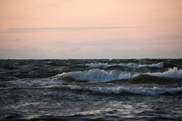 waves with foam at sea in the evening
