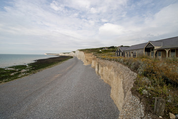 Obraz premium The famous Seven Sisters chalk cliffs by the English Channel. They form part of the South Downs in East Sussex, between the towns of Seaford and Eastbourne in southern England, taken on a bright day.