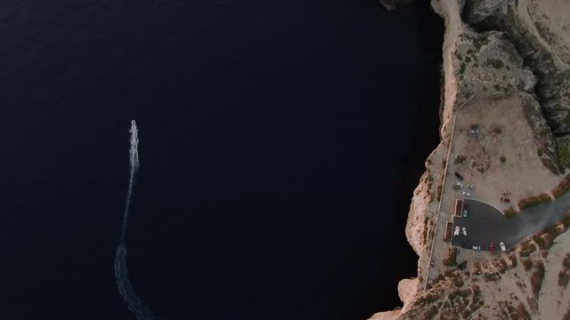 High Top View of a small boat by the Cliffs in Dingli