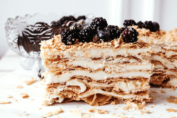 Homemade Napoleon Cake with blackberry. Menu for cafe, delicious puff dessert. Section, texture, closeup.