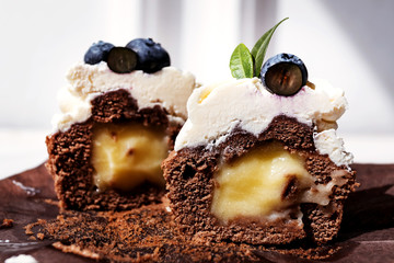 Berry cupcakes with filling, cut. Dessert for birthday, wedding, celebration. Decoration in chocolate tone.