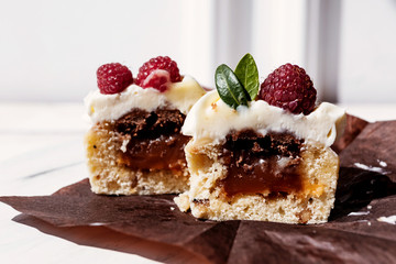 Berry cupcakes with filling, cut. Dessert for birthday, wedding, celebration. Decoration in chocolate tone.