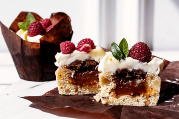 Berry cupcakes with filling, cut. Dessert for birthday, wedding, celebration. Decoration in chocolate tone.