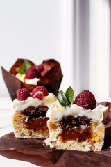 Berry cupcakes with filling, cut. Dessert for birthday, wedding, celebration. Decoration in chocolate tone.