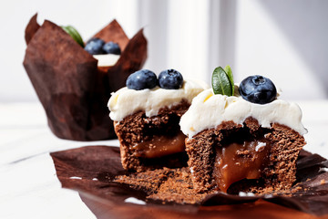 Berry cupcakes with filling, cut. Dessert for birthday, wedding, celebration. Decoration in chocolate tone.