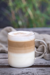 Coffee cafe latte macchiato outdoors in a glass cup