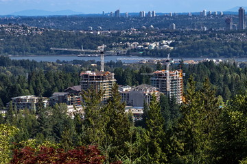 Fototapeta premium Construction site in the green zone of North Vancouver at the background of Burrard inlet and Vancouver City