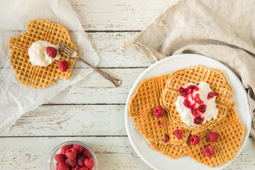 Waffles with raspberries and cream seen from above