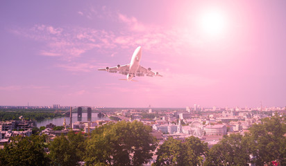 The plane over the city and plants. sunset.