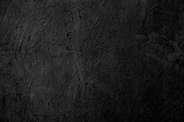 The texture of the wood particle board painted black color.