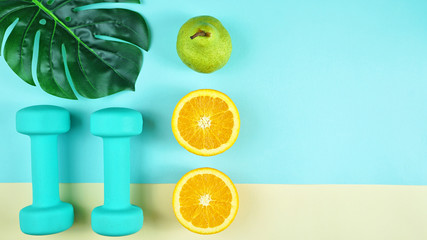 Health and fitness concept flatlay with exercise equipment on modern colorful background with copy space.