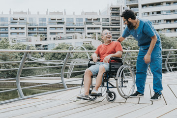 disabled man who goes in a wheelchair is transported by a doctor