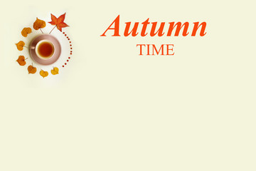 Cup of tea among autumn leaves