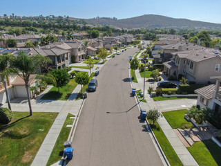 Suburban neighborhood street with big villas next to each other in Black Mountain, San Diego, California, USA. Aerial view of residential modern subdivision luxury house.