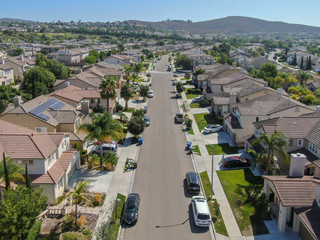 Suburban neighborhood street with big villas next to each other in Black Mountain, San Diego, California, USA. Aerial view of residential modern subdivision luxury house. - obrazy, fototapety, plakaty