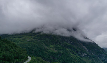 The top part of the famous road Trollstigen in Norway, with beautiful clouds in the background with amazing mountains. July 2019