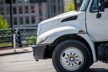 Medium class rig semi truck tractor running on the city street