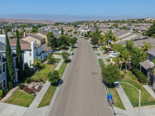 Suburban neighborhood street with big villas next to each other in Black Mountain, San Diego, California, USA. Aerial view of residential modern subdivision luxury house.