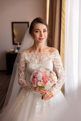 Portrait of beautiful bride with wedding bouquet
