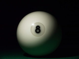 White ball number 8 from russian billiard pyramid in the dark