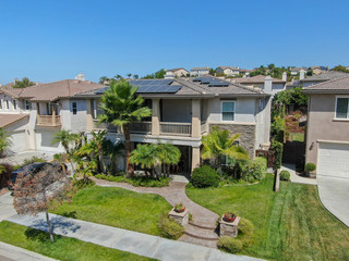 Fototapeta na wymiar Aerial view suburban neighborhood with big villas next to each other in Black Mountain, San Diego, California, USA. Aerial view of residential modern subdivision luxury house.