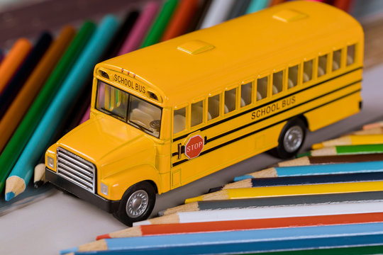 Toy school bus with color wooden pencils.