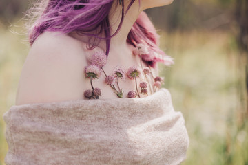 Woman with colorful dyed hair and flowers.