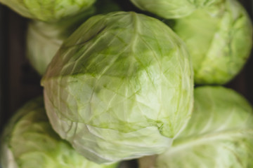 Fototapeta premium Group of green cabbages in a supermarket, Cabbage background. Selective focus