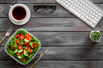 meal in lunch box and coffee for dinner on wooden office desk background with keyboard top view mockup