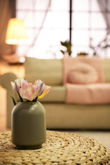 Beautiful flowers on table in cozy living room, space for text. Stylish interior design