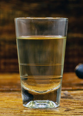 Several glasses of brazilian cachaça isolated on rustic wooden background, variations and types of brazil cachaça, typical drink from brazil.