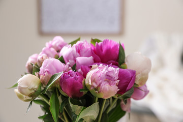 Bouquet of beautiful peonies in room, closeup