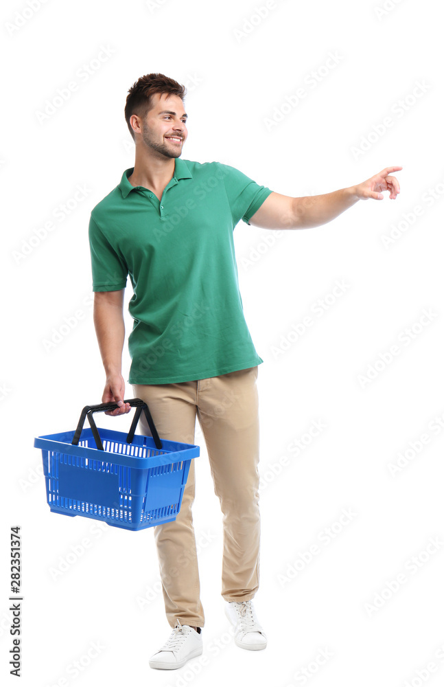 Wall mural Young man with empty shopping basket isolated on white