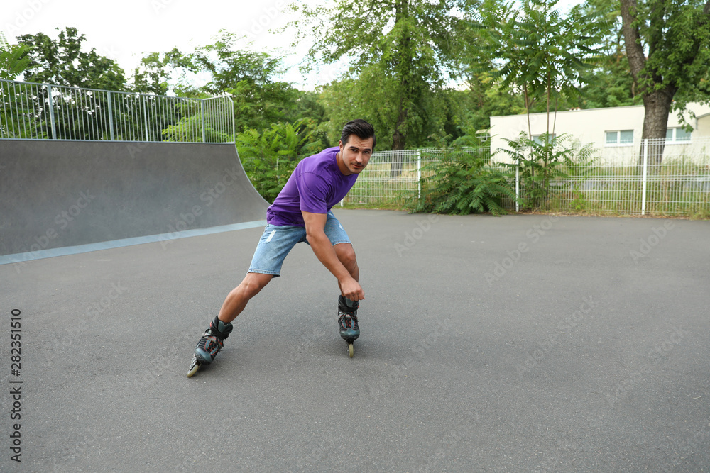 Canvas Prints Handsome young man roller skating in park