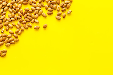 Almond on yellow background top view space for text