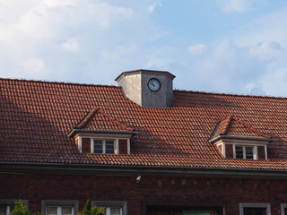 Old building with tiled roof, two attics and clock (Szczecin Poland)
