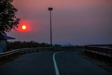 Blurred wallpaper of colorful, twilight sky by the sea, with lights from the street shining at night, beautiful natural occurrences, seen in scenic spots or tourist attractions