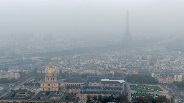 Aerial: Les Invalides and Surrounding City with Hazy Eiffel Tower in Paris, France
