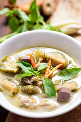 Thai green curry chicken (Kang Keaw Wan Kai) in a bowl on wooden, Thai food