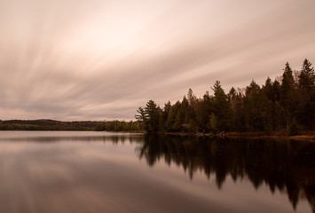 Lake scene with long exposure of water and sky Algonquin Park Ontario Canada