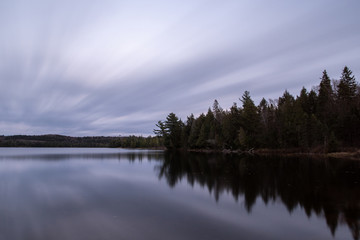 Lake scene with long exposure of water and sky Algonquin Park Ontario Canada