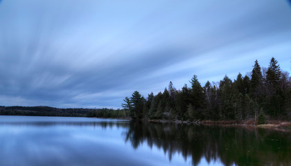 Lake scene with long exposure of water and sky Algonquin Park Ontario Canada