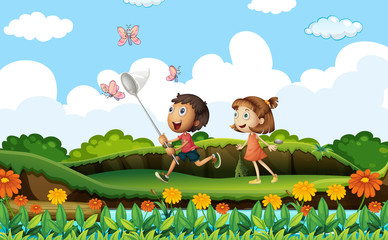 Two kids catching butterflies in the park