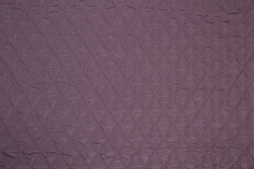 Quilted fabric. The texture of the blanket.