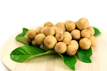 LongKong is placed on a wooden tray. Tropical fruit, Langsat, lanzones, Lansium parasiticum on a white background. - Image