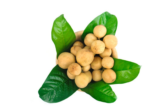LongKong is placed on a wooden tray. Tropical fruit, Langsat, lanzones, Lansium parasiticum on a white background. - Image