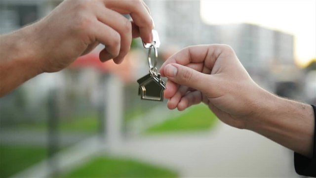 The Developer Passes The Key Of The New Home To The Buyer.