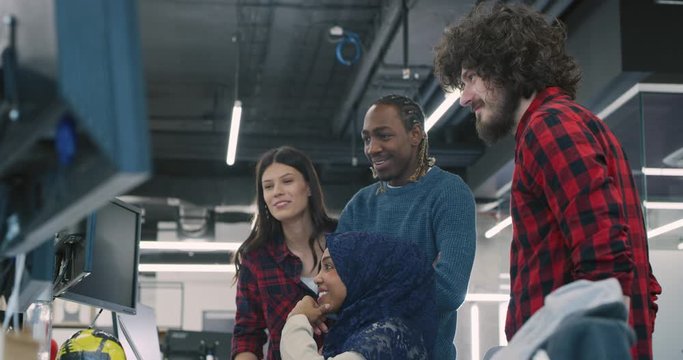 Young multiethnic business team of software developers working together using