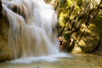 Woman with black bikini in waterfall