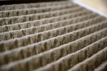 Dirty and dusty used house air filter close-up     